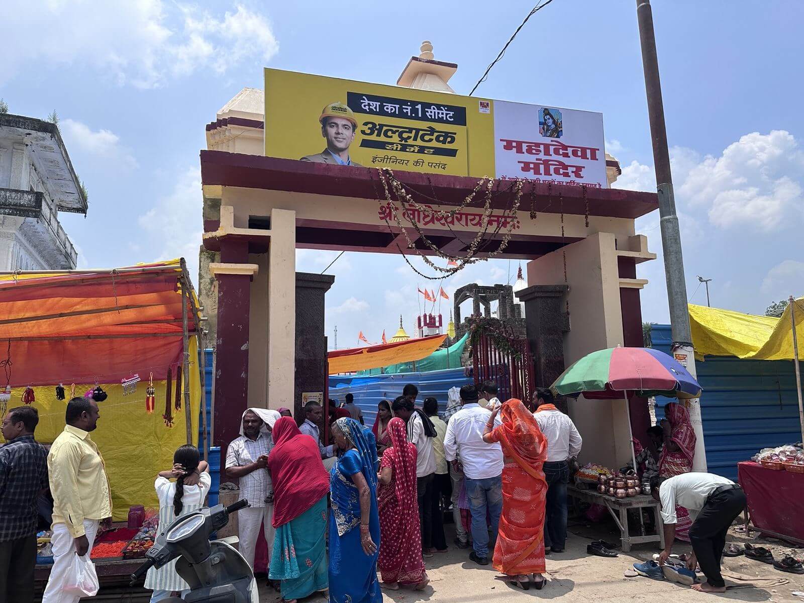 Crowded gateway of Mahadeva Mandir with marigold garlands