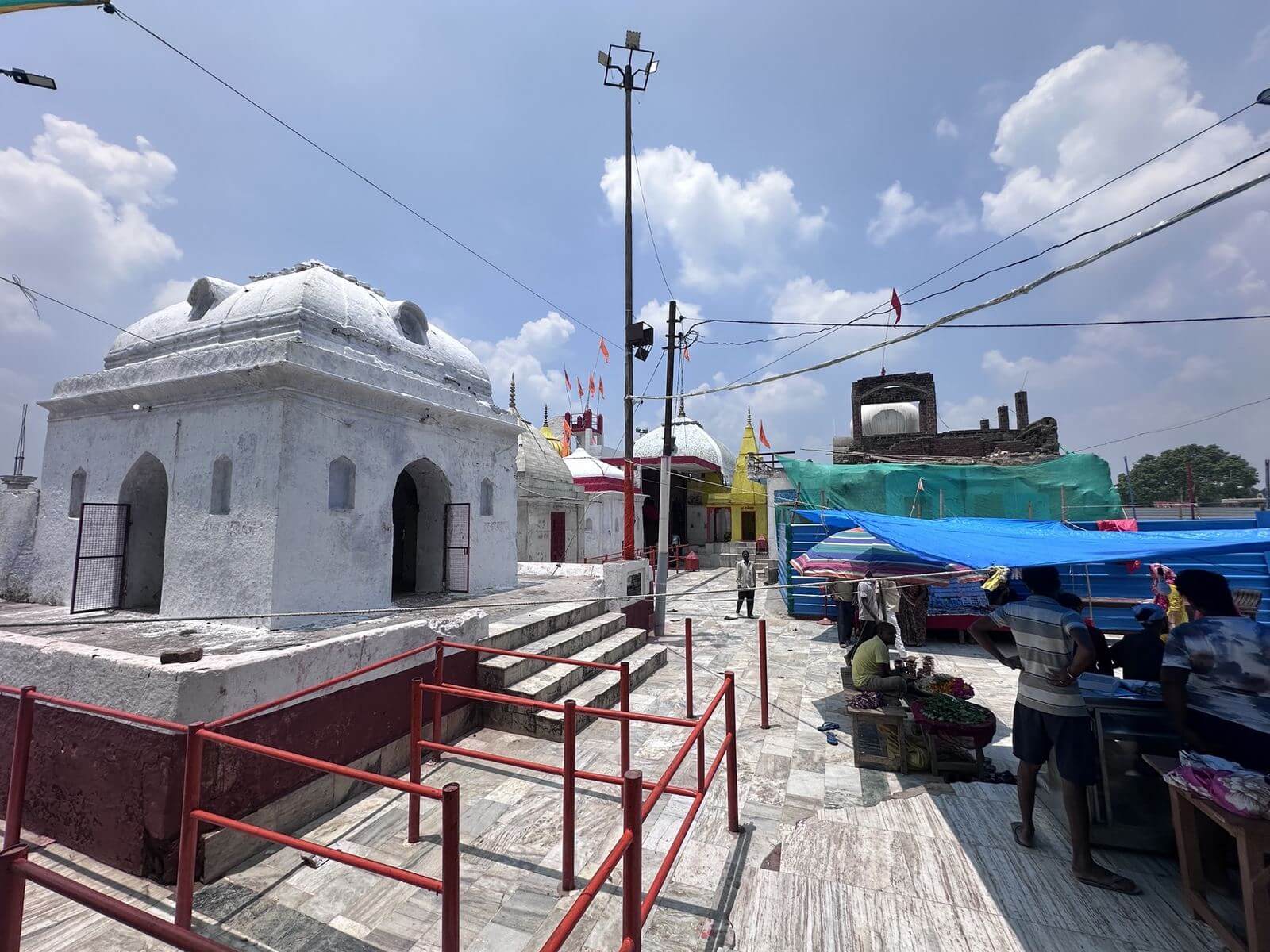 White shrines in the temple courtyard under a blue sky