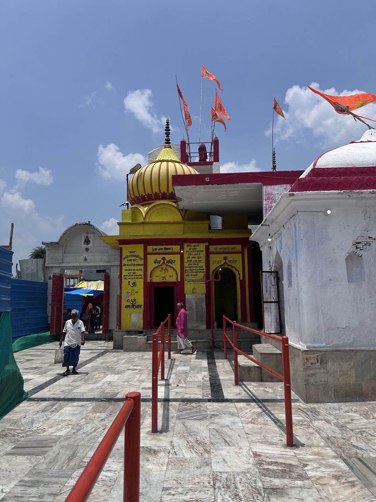 Bharon Mandir with golden shikhara and saffron flags
